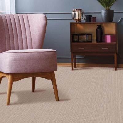 stylish living room with carpets, blue accent wall and pink chair